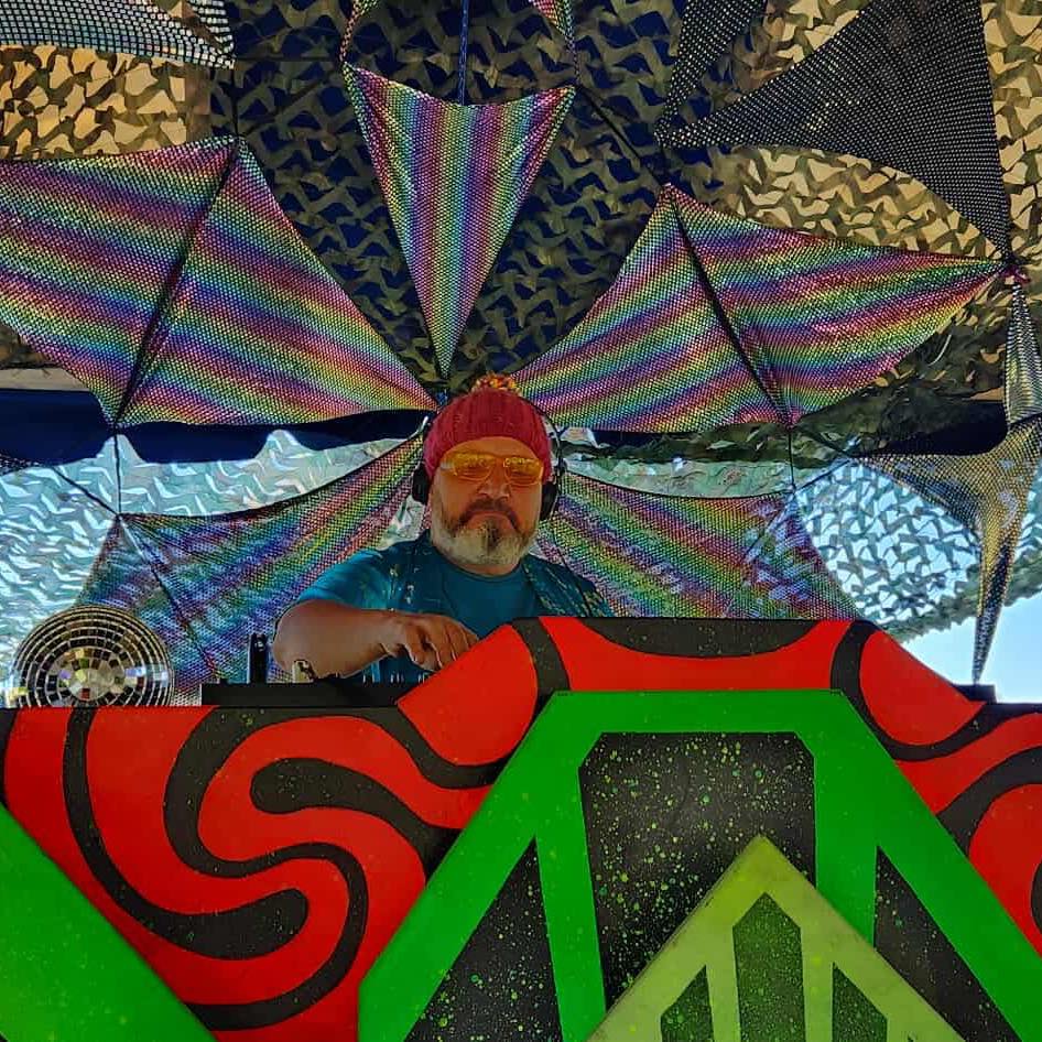 DJ mixing live on professional decks at a Sunshine Coast event with crowd engagement